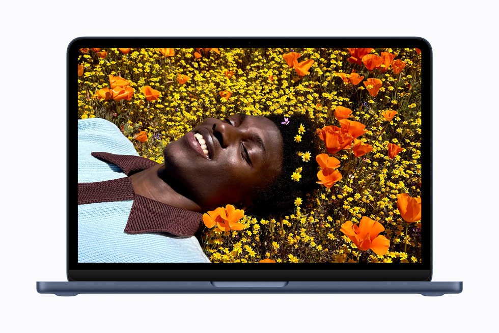 An open MacBook Neo viewed from the front, with a photograph on its display